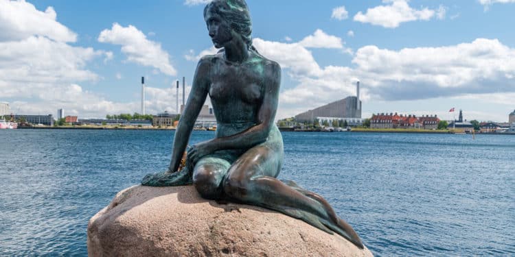 Copenhagen, Denmark - July 26, 2022: Statue of The Little Mermaid at Langelinie. The Little Mermaid (Danish: Den lille Havfrue), bronze statue by Edvard Eriksen.