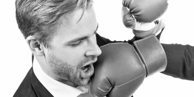 Lose situation. Businessman punched in face. Young man punched with boxing glove. Defeated in fight