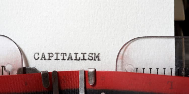 The word capitalism  written with a typewriter.
